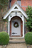 Christmas wreath on front porch of Lymington home  Hampshire  UK