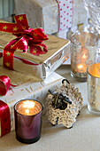 Lit tealights and Christmas presents in Lymington home  Hampshire  UK