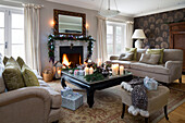 Christmas garland with fairylights above lit fire in living room of Chobham home   Surrey   England   UK