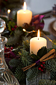 Lit candles with cinnamon sticks in Chobham home at Christmas   Surrey   England   UK