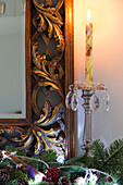 Lit candle with leaf framed mirror in Chobham home   Surrey   England   UK