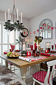 Lit candelabra above dining table set for Christmas dinner in Surrey home   England   UK