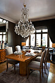 Cut glass chandelier above polished dining table in London townhouse   England   UK