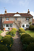 Brick footpath to stone exterior of detached East Dean home  West Sussex  UK