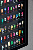 Collection of foil goblets in display cabinet, London home, England, UK
