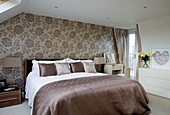Co-ordinated feature wall in bedroom of contemporary London home, England, UK