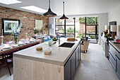 Open plan kitchen diner extension with exposed brickwork in London home, England, UK
