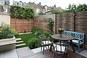 Garden furniture and fencing in exterior of urban London home, England, UK