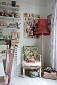 Standard lamp and pinboard with floral upholstered chair in Norfolk work studio England UK