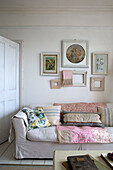 Framed prints above sofa in Norfolk home England UK