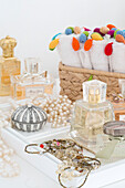 Perfume bottles and jewellery with rolled towels in London townhouse UK