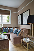 Black lampshade with blue velvet cushions on brown sofa in London townhouse England UK