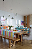 Striped tablecloth on dining table in open plan room of Lechlade home Gloucestershire England UK