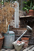 Metal watering can with crates and flower pots in Arundel sun room West Sussex England UK
