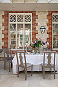 Dining room conservatory extension in renovated Victorian schoolhouse West Sussex England UK