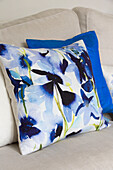 Blue floral cushion on sofa in London townhouse UK