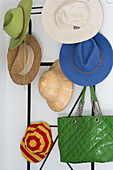 Assorted sunhats with green handbag in Var farmhouse Provence France