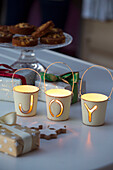 Candle holders spelling 'JOY' with cookies and gifts in Sussex home England UK