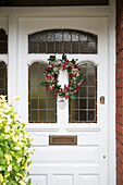 Christmas wreath on front door of London home England UK