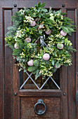 Christmas wreath on wooden front door in Kent England UK