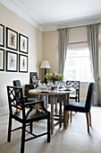Dining table and framed prints in London townhouse apartment UK
