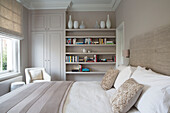Vases and books on bedroom shelving in Victorian terraced house London England UK