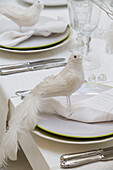 White bird napkin holders on place setting at dining table in South London home England UK