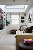 Television in bookcase with sofa in London townhouse England UK
