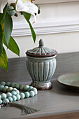 Ceramic green urn and necklace in Worcestershire home England UK