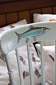 Fish on painted chair back with hare on cushions in Kelso home Scotland UK