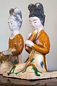 Two kneeling ceramic figurines of musicians in Gloucestershire farmhouse England UK