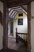 Mistletoe on candelabra in timber-framed landing of Hampshire farmhouse England UK