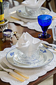 Blue wineglass at place setting with napkin on dining table in Georgian rectory Northamptonshire England UK