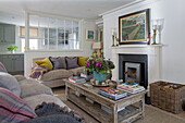 Living room partitioned from kitchen with glass wall in West Sussex home