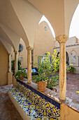 Blue and yellow tiled seating in courtyard of Italian villa on the Amalfi coast