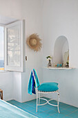 White chair at recessed dressing table with sunhat in Italian villa on the Amalfi coast