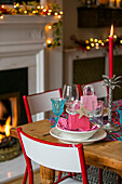 Personalised place setting with lit candle on dining table at Christmas in Hove apartment East Sussex UK