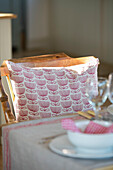 Patterned cushion on dining chair at table in West Sussex farmhouse UK