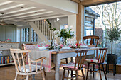 Wineglasses on dining table at window in West Sussex farmhouse UK