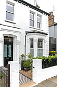 Black front door and whit paintwork on exterior of Victorian semi-detached home London UK