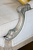 Ageing paintwork on arm of chair in Grade II listed villa Arundel West Sussex UK