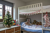 Christmas stocking and tree with teddybears on bunkbed in Arts and Crafts home West Sussex UK