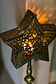 Star shaped candle holder at Christmas in Hampshire home