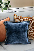 Assorted cushions on sofa in Wiltshire home England UK