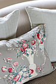 Floral cushion on sofa in Somerset farmhouse UK