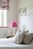 Pink lampshade at bedside in Somerset farmhouse UK