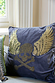 Winged skull and crossbones on cushion in detached Kent home UK