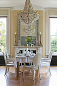 Large seashell pendant light above dining table in detached Kent home UK