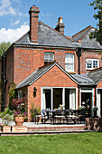 Garden furniture on terrace of brick Hampshire home UK