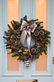 Christmas wreath on front door painted Blue Ground - Edwardian home in East Dulwich London UK